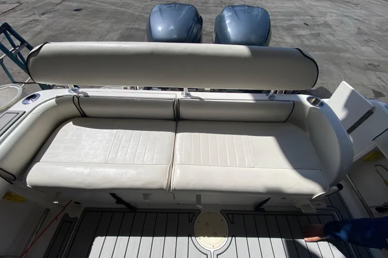 Slide: The Image of 2007 Robalo R265 Walkaround boat with cushioned seating and dual outboard motors. - 23