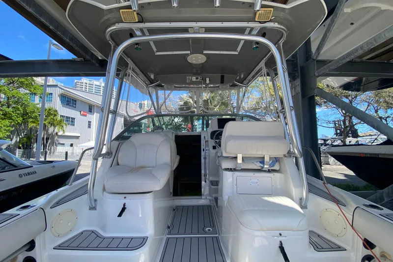 Slide: The Image of 2007 Robalo R265 Walkaround boat interior with seating and helm, docked outdoors. - 24