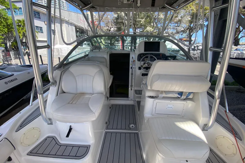 Slide: The Image of 2007 Robalo R265 Walkaround boat interior with white seating and steering console. - 25