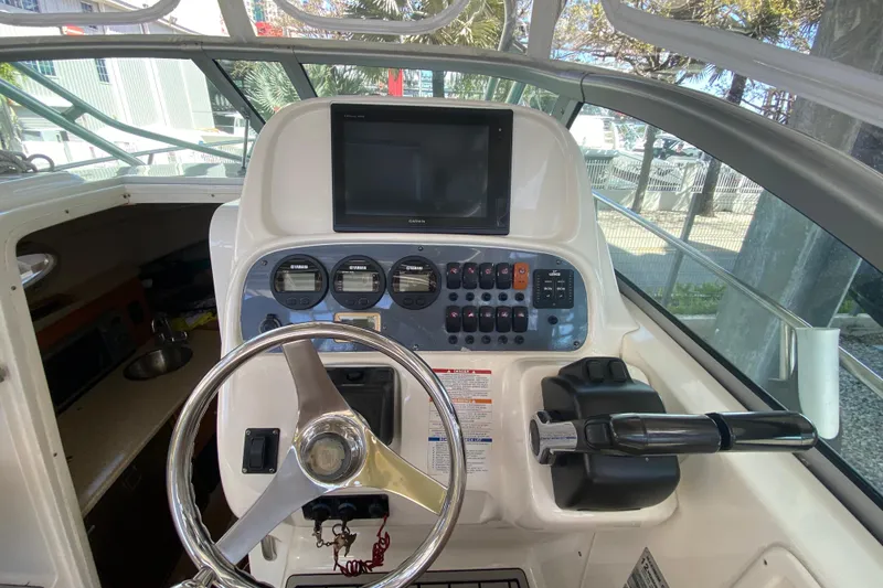 Slide: The Image of 2007 Robalo R265 Walkaround boat helm with steering wheel and control panel. - 28