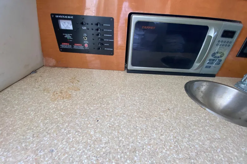 Slide: The Image of 2007 Robalo R265 Walkaround interior with microwave, sink, and control panel. - 38