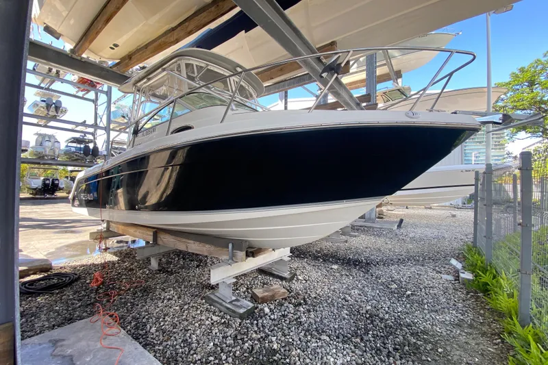 Slide: The Image of 2007 Robalo R265 Walkaround boat stored on a rack in a marina. - 4