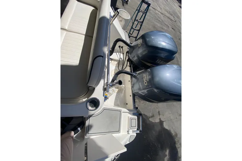 Slide: The Image of 2007 Robalo R265 Walkaround boat with dual Yamaha 250 engines, docked. - 42