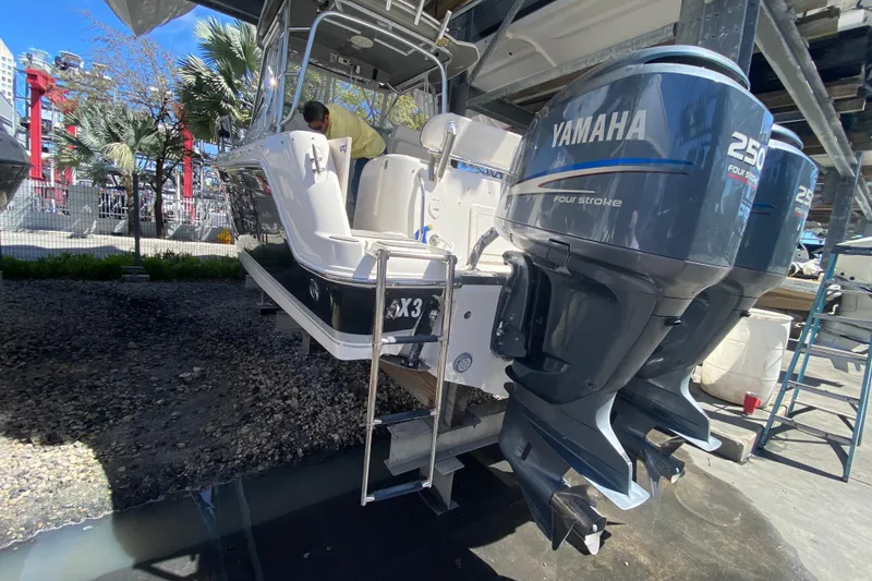 Slide: The Image of 2007 Robalo R265 Walkaround boat with twin Yamaha 250 engines on a lift. - 44