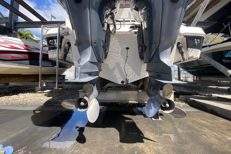 Slide: The Image of 2007 Robalo R265 Walkaround boat with dual outboard motors in storage. - 47