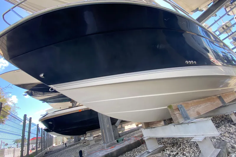 Slide: The Image of 2007 Robalo R265 Walkaround boat on dry dock, showcasing sleek hull design. - 6