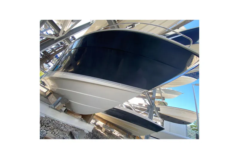 Slide: The Image of 2007 Robalo R265 Walkaround boat on dry dock, showcasing sleek hull design. - 7