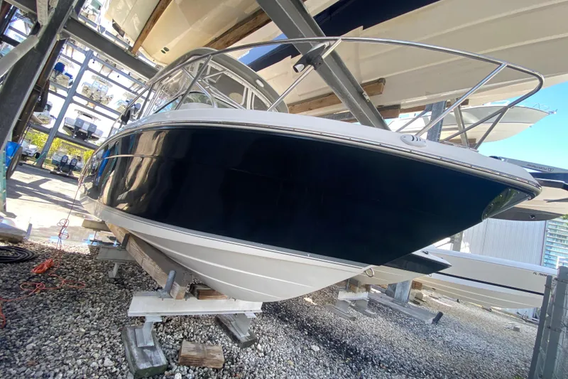 Slide: The Image of 2007 Robalo R265 Walkaround boat on dry dock, side view. - 8