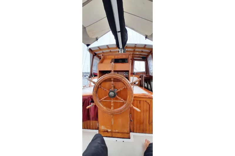 Slide: The Image of Wooden steering wheel on 1974 Force Hudson 50 boat deck. - 14