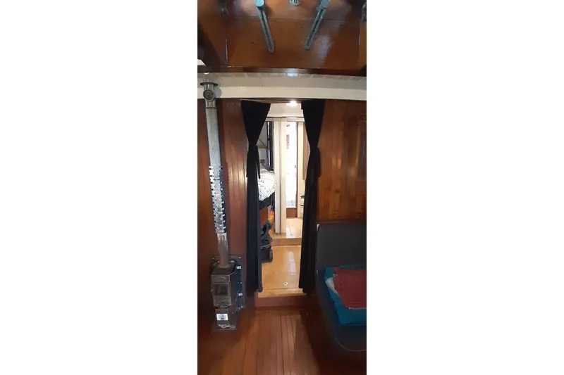 Slide: The Image of Interior of 1974 Force Hudson 50 boat with wooden paneling and cozy cabin space. - 16