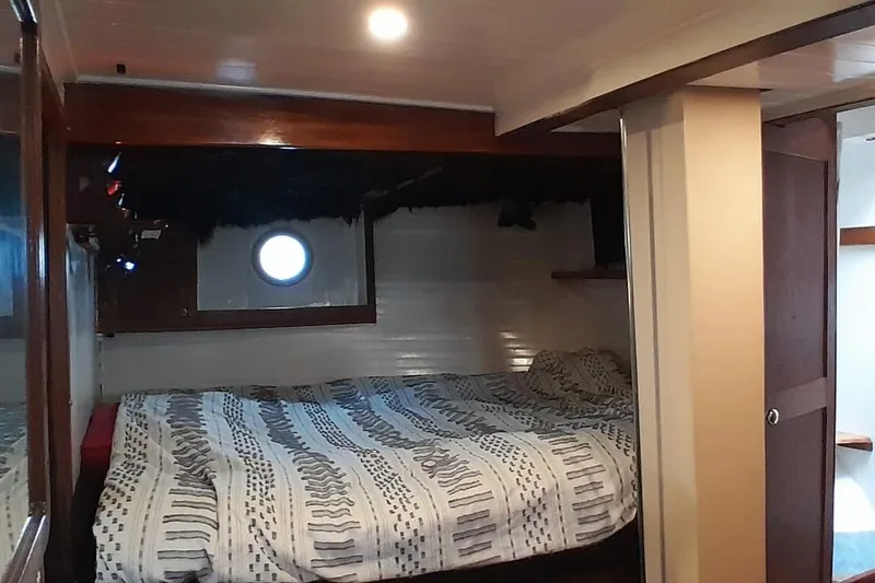 Slide: The Image of Cozy cabin interior of 1974 Force Hudson 50 boat with bed and porthole window. - 20