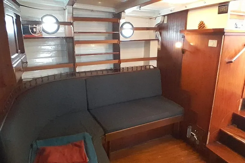 Slide: The Image of Interior of 1974 Force Hudson 50 boat with wooden furnishings and cozy seating area. - 21