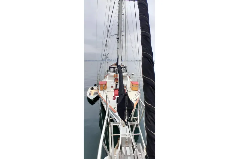 Slide: The Image of 1974 Force Hudson 50 sailboat on calm water, view from the bow. - 33