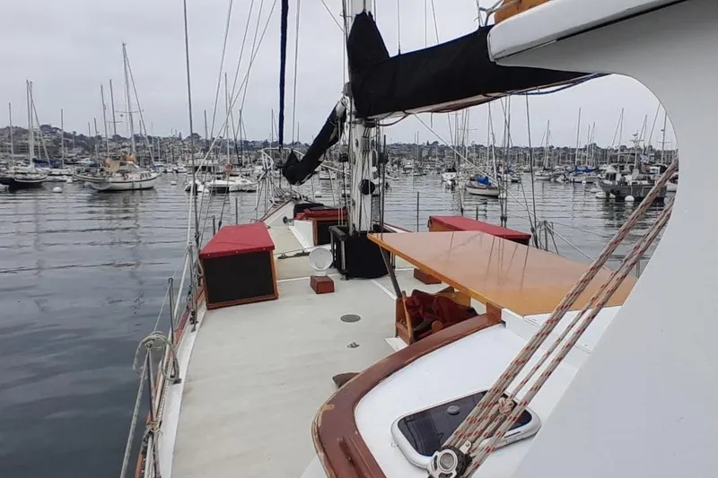 Slide: The Image of 1974 Force Hudson 50 sailboat docked in a marina, surrounded by other boats. - 41