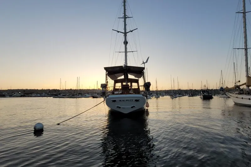 Slide: The Image of Sailboat "Force Hudson 50" at sunset in a tranquil marina, 1974 model. - 44