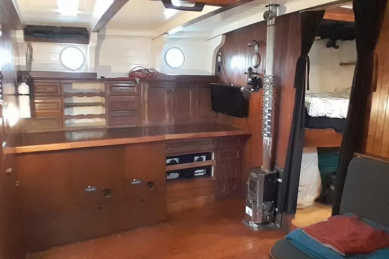Slide: The Image of 1974 Force Hudson 50 yacht interior with wooden cabinetry and cozy sleeping area. - 46