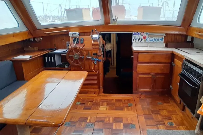 Slide: The Image of 1974 Force Hudson 50 yacht interior with wooden furnishings and steering wheel. - 48