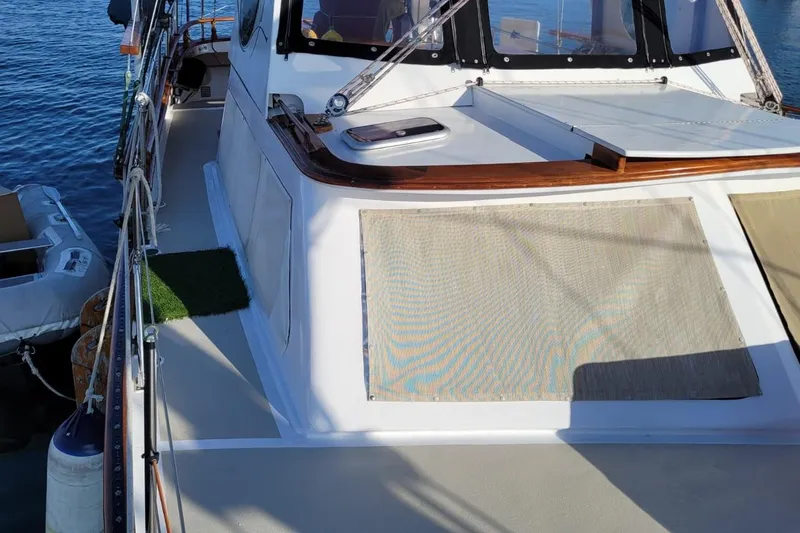 Slide: The Image of 1974 Force Hudson 50 yacht deck with sunshade, docked by the water. - 5