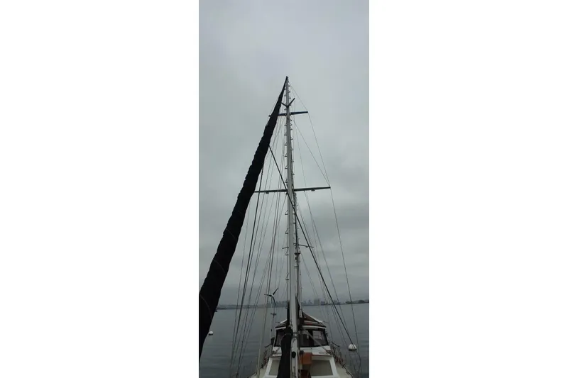 Slide: The Image of Mast of 1974 Force Hudson 50 sailboat against cloudy sky. - 50