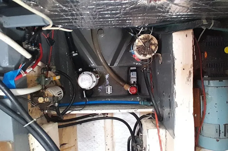 Slide: The Image of Engine compartment of a 1974 Force Hudson 50 with visible wiring and components. - 51