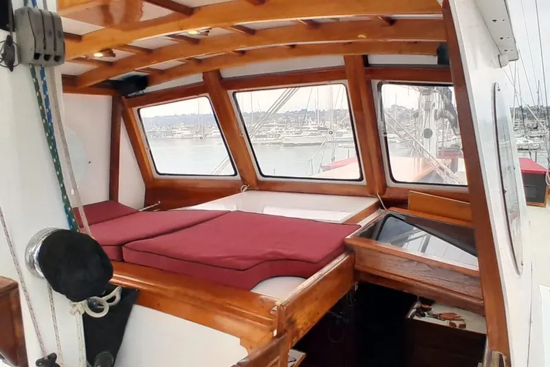 Slide: The Image of Interior of 1974 Force Hudson 50 sailboat with wooden accents and marina view. - 53
