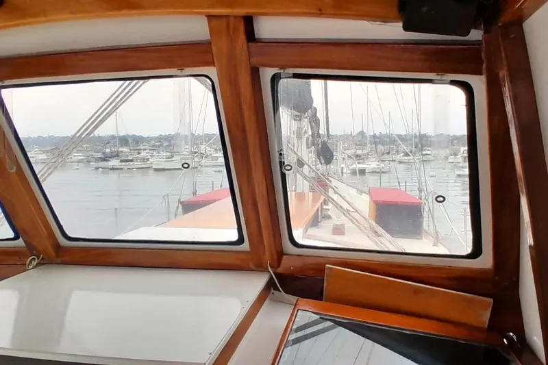 Slide: The Image of 1974 Force Hudson 50 yacht interior view with marina in background. - 54