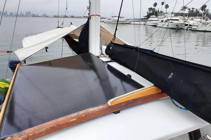 Slide: The Image of Sailboat deck with solar panel, docked near marina, featuring Force Hudson 50, 1974 model. - 57