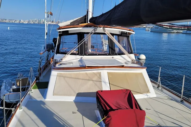 Slide: The Image of 1974 Force Hudson 50 sailboat on calm water with city skyline in background. - 7