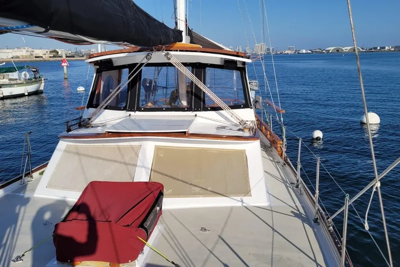 Slide: The Image of 1974 Force Hudson 50 sailboat docked in a marina with clear blue water. - 8