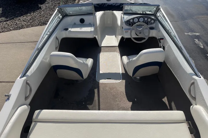 Slide: The Image of 2013 Stingray 191 RX boat interior with steering wheel and seating. - 8