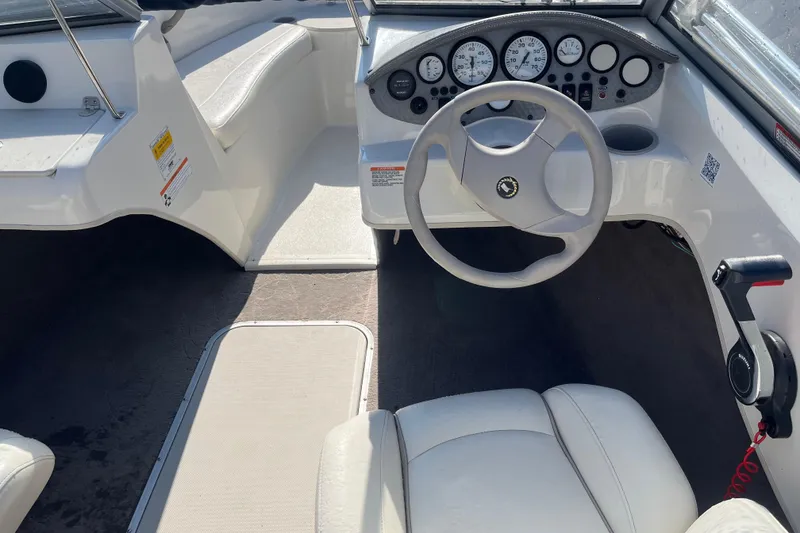Slide: The Image of Interior of a 2013 Stingray 191 RX boat featuring steering wheel and dashboard controls. - 9