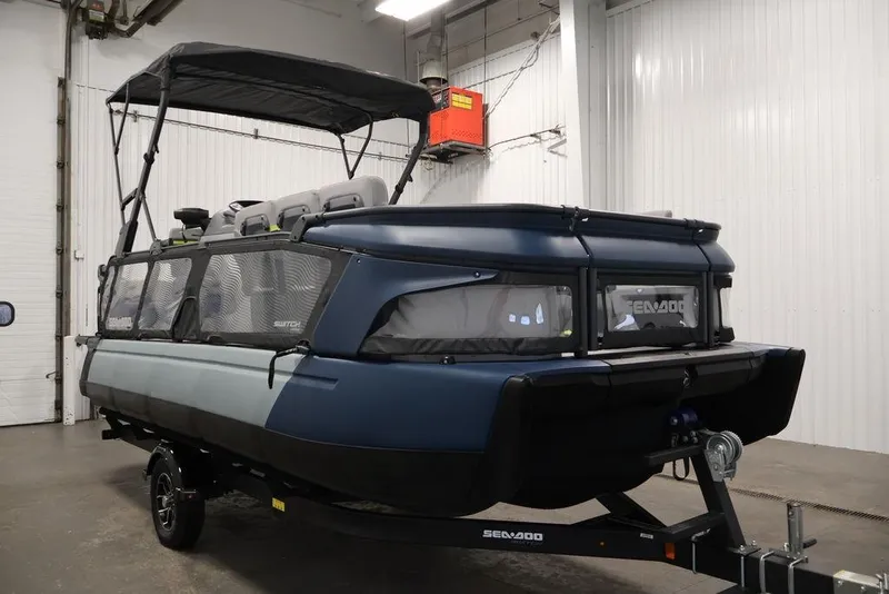 Slide: The Image of 2025 Sea-Doo Switch Cruise 21 pontoon boat in a showroom, featuring sleek design and modern features. - 3