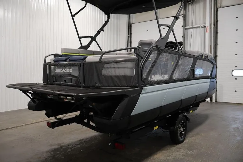 Slide: The Image of 2025 Sea-Doo Switch Cruise 21 pontoon boat in a garage setting. - 4