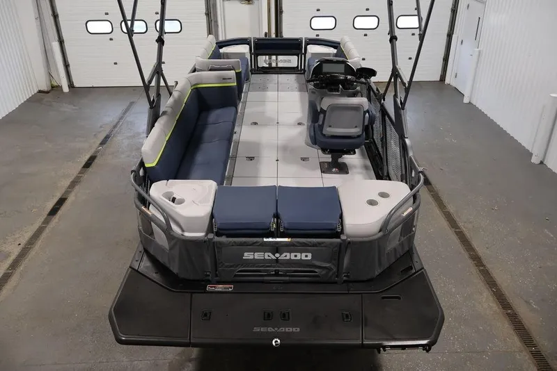 Slide: The Image of 2025 Sea-Doo Switch Cruise 21 pontoon boat in a garage, showcasing spacious seating. - 9