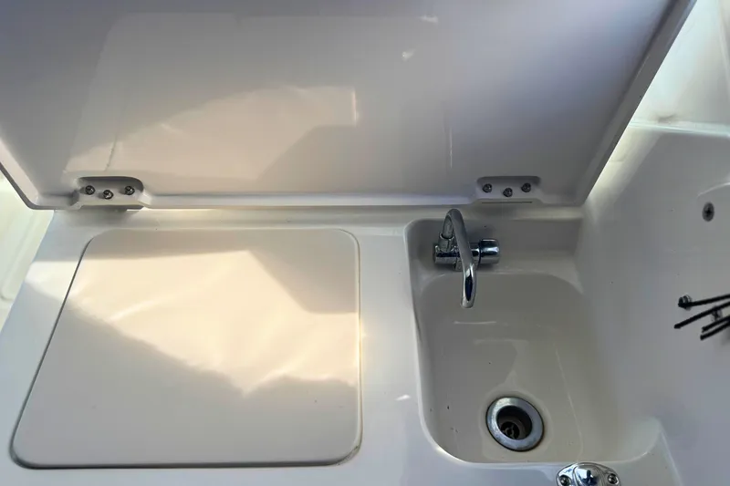 Slide: The Image of 2023 Pursuit DC 266 Dual Console boat sink and countertop detail. - 10