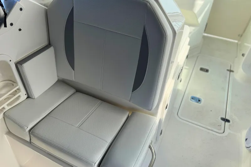 Slide: The Image of 2023 Pursuit DC 266 Dual Console boat interior with gray seating and deck view. - 12