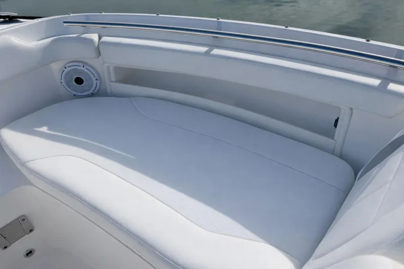 Slide: The Image of 2023 Pursuit DC 266 Dual Console boat interior with white cushioned seating. - 26
