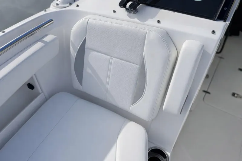 Slide: The Image of 2023 Pursuit DC 266 Dual Console boat seat with white upholstery and armrest. - 27