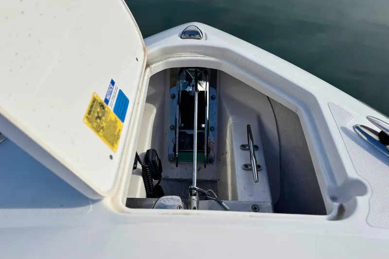 Slide: The Image of 2023 Pursuit DC 266 Dual Console anchor compartment, open lid, detailed view. - 29