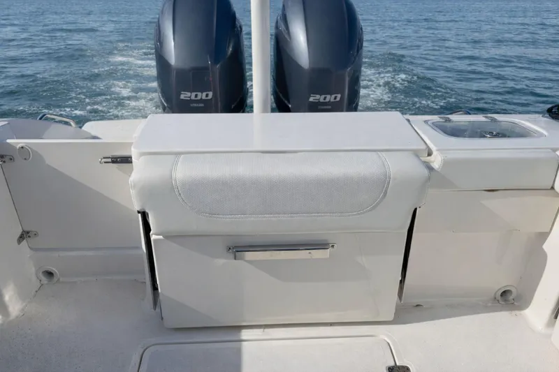 Slide: The Image of 2023 Pursuit DC 266 Dual Console boat with twin Yamaha 200 engines on open water. - 3