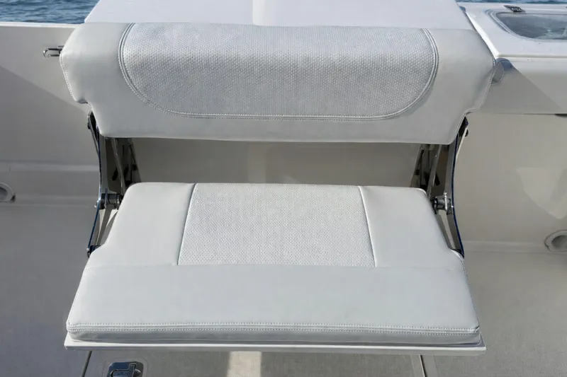 Slide: The Image of 2023 Pursuit DC 266 Dual Console boat seat, featuring sleek white upholstery. - 4