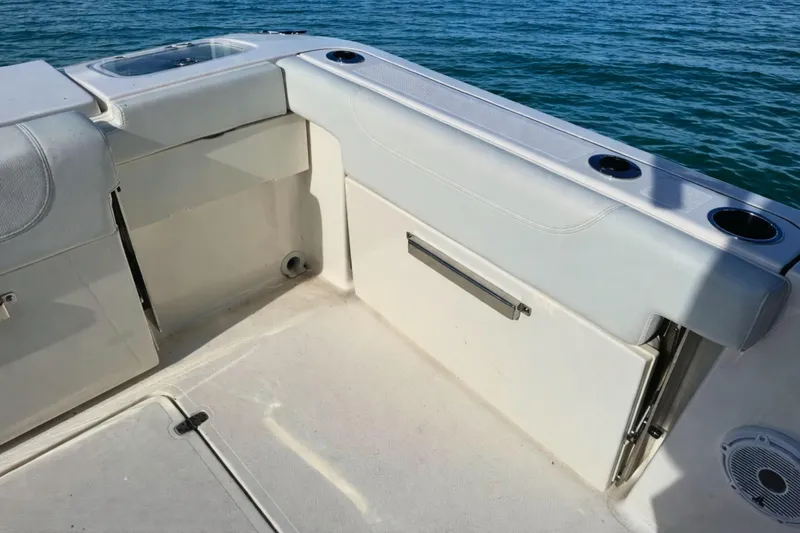 Slide: The Image of 2023 Pursuit DC 266 Dual Console boat interior with cup holders and storage. - 5