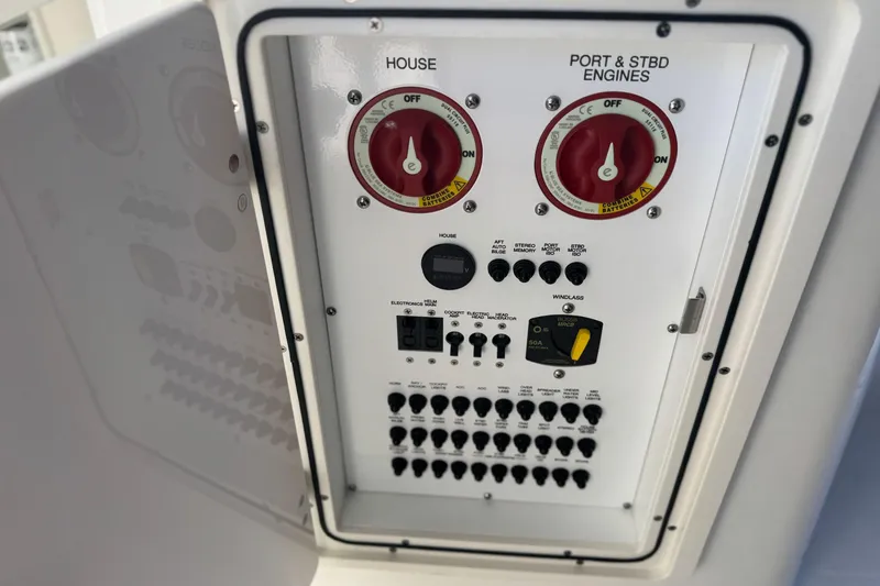 Slide: The Image of Control panel of 2023 Pursuit DC 266 Dual Console boat, featuring switches and dials. - 8