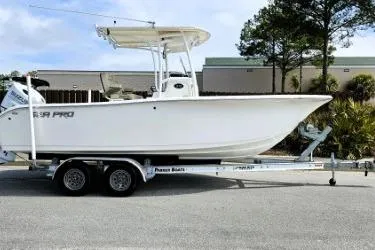 The Image of 2023 Sea Pro 219 Center Console boat on trailer, parked outdoors. - 1
