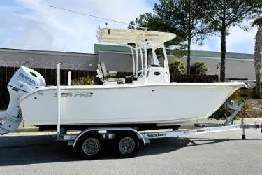 Slide: The Image of 2023 Sea Pro 219 Center Console boat on trailer, parked outdoors. - 12
