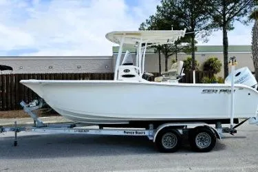 Slide: The Image of 2023 Sea Pro 219 Center Console boat on trailer, parked outdoors. - 14