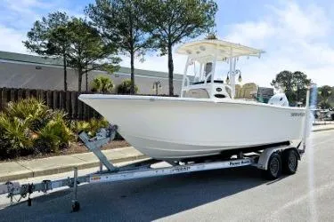 Slide: The Image of 2023 Sea Pro 219 Center Console boat on trailer, parked outdoors. - 17