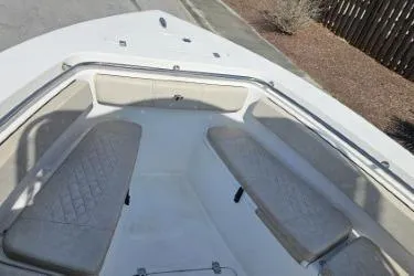 Slide: The Image of 2023 Sea Pro 219 Center Console boat interior with cushioned seating and storage. - 19