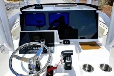 Slide: The Image of 2023 Sea Pro 219 Center Console dashboard with steering wheel and navigation screens. - 21