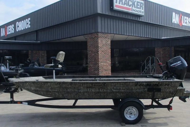 The Image of 2026 Tracker Grizzly 1654 T Sportsman boat on trailer outside Anglers Choice store. - 1